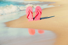 Pink Flip Flops In The Sand On The Beach