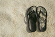 Beach shoes sandals flip-flops on sandy beach