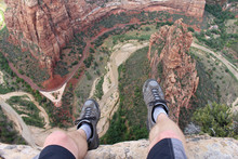 First Person Perspective Shot From A Hiker Sitting At The Edge Of A Cliff At Angel's Landing In Zion National Park.