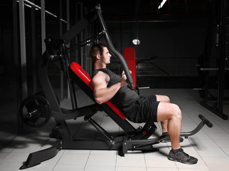 Young handsome man training in gym