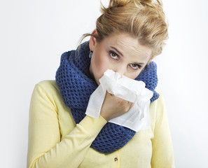 Young blond sick Rhinitis. Stuffy nose. Runny nose.blonde with a handkerchief.
