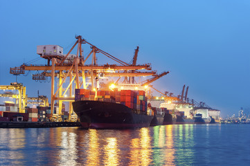 Wall Mural - Containers loading by big crane at dark sunset, Shipping Trade Port in Thailand