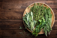 Various Fresh Herbs, Rosemary, Thyme, Mint And Sage On Wooden Background