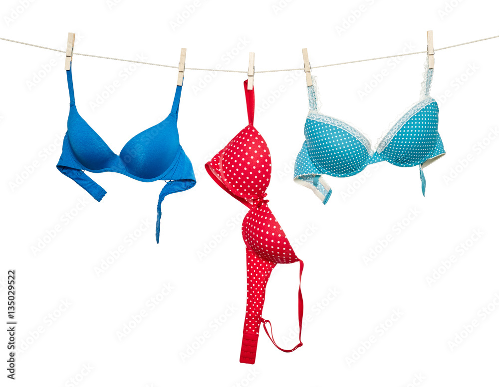 Female color bra hanging on rope - obrazy, fototapety, plakaty 