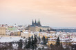 View of Prague and its Castle under the snow at sunset