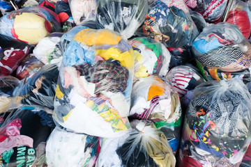 old second-hand clothes in plastic bags