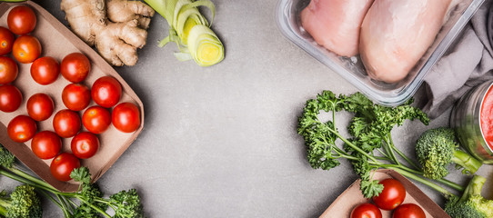 Raw chicken breast fillet  and various vegetables ingredients for tasty diet cooking, gray stone background  , top view, copy space, banner