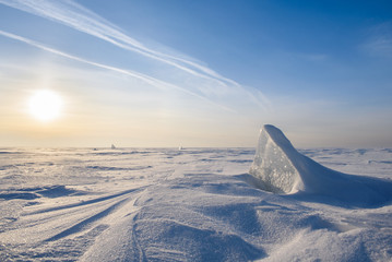 Wall Mural - blocks of ice gleaming in the sun, snow, frost, frozen water surface.