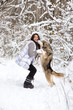 © serbinov - Girl with Husky in winter forest. Dog licking girl on the cheek