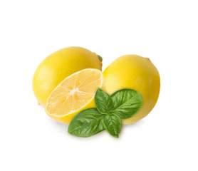 Two lemons and halves isolated on white background. Ripe lemons with basil close-up. Background citrus.