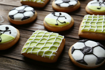 Poster - Tasty football cookies on wooden table, closeup