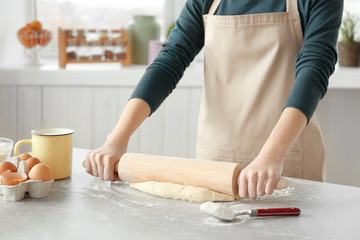 Canvas Print - Woman preparing dough on table at kitchen