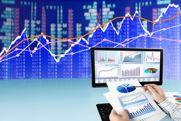 Fototapete - Man analyzing financial data and charts on computer 