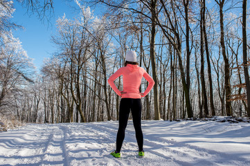 Wall Mural - Runner girl in sunny winter forest