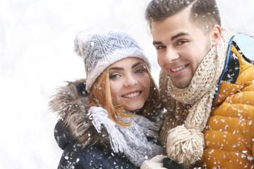 Canvas Print - Young couple in snowfall outdoor