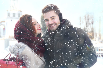 Wall Mural - Young couple in snowfall outdoor