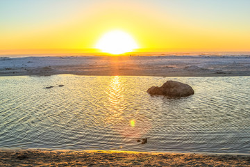 Calm sea at sunset with golden background and copy space. Noordoek Beach in Table Mountain National Park, Cape Town, South Africa. Peace, relaxation, summer, holidays concept.