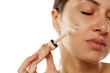 © vladimirfloyd - A young woman applied with a pipette three different shades of foundation