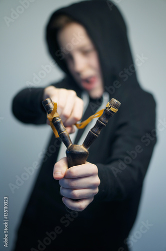Teenage Bad Boy With Slingshot And Stylish Haircut Studio Shot