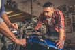 © georgerudy - Guys at the motorbike repair shop