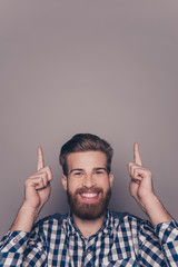 Wall Mural - Portrait of  happy bearded man pointing fingers up