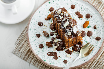 Wall Mural - Tasty piece of chocolate Spartak cake on a rustic plate. Traditional delicious dessert on a table. Top view shot.