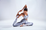 Fototapeta Konie - Woman doing yoga isolated on white background