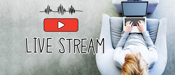 Wall Mural - live stream text with man using a laptop