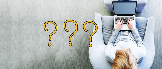 Wall Mural - question mark text with man using a laptop