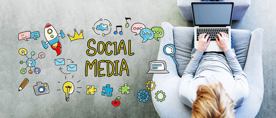 Wall Mural - social media text with man using a laptop