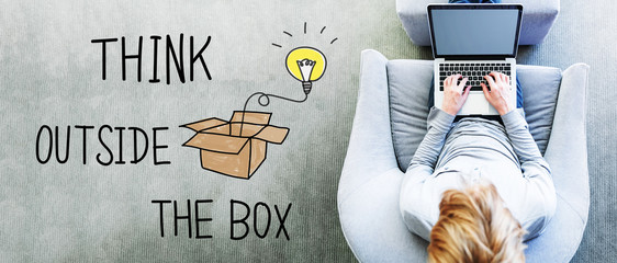 Wall Mural - think outside the box text with man using a laptop
