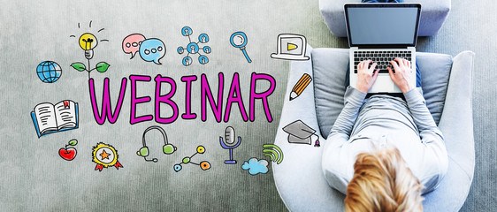 Wall Mural - webinar text with man using a laptop
