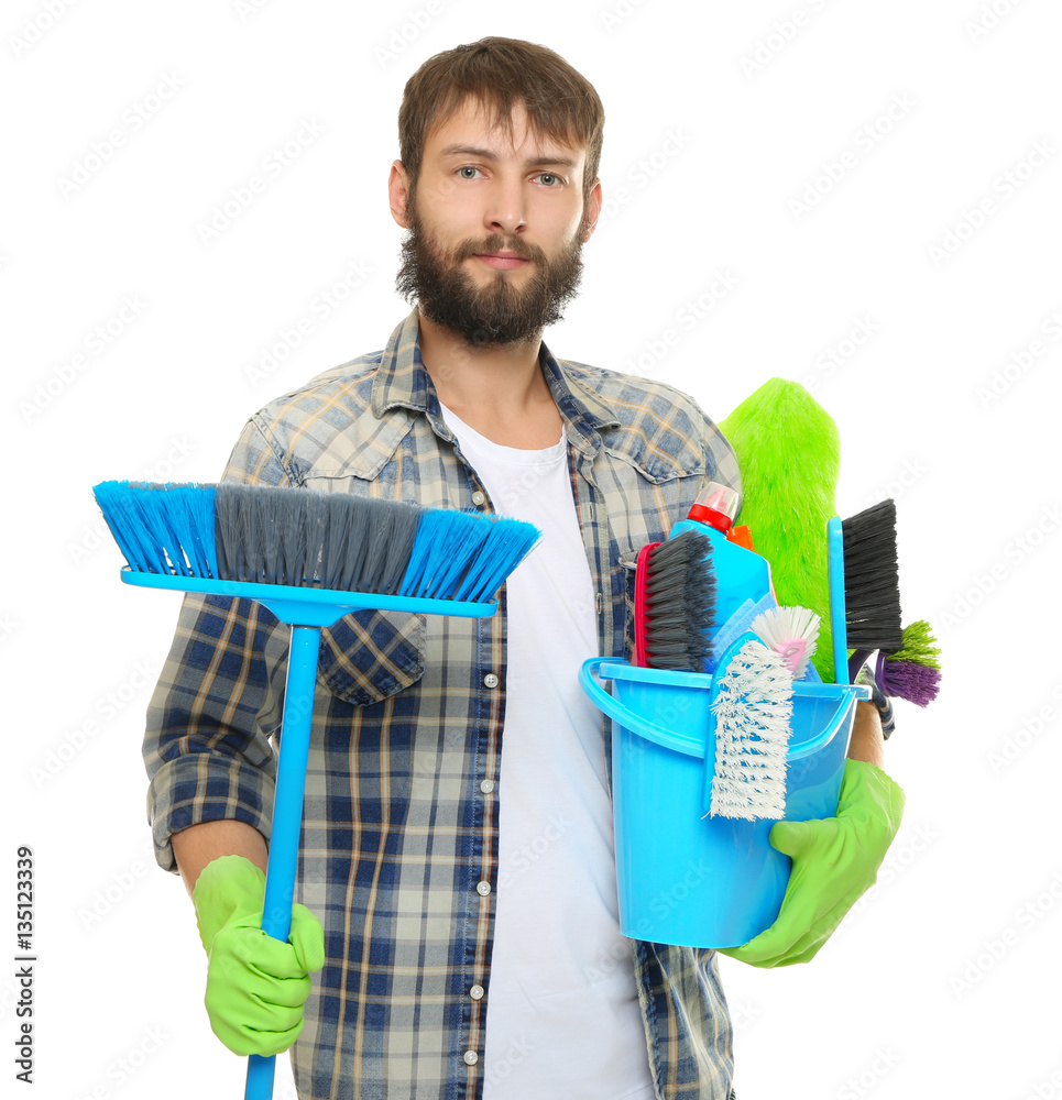 Young man with cleaning supplies on white background
