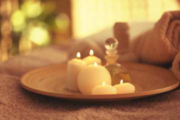 Poster - Spa set with candles, oil  and towel on blurred background