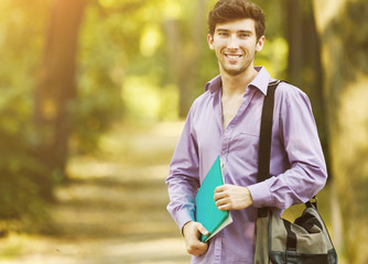 successful student with books in the Park on a Sunny day.