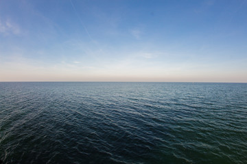Wall Mural - smooth sea with clear blue sky background at the baltic coast
