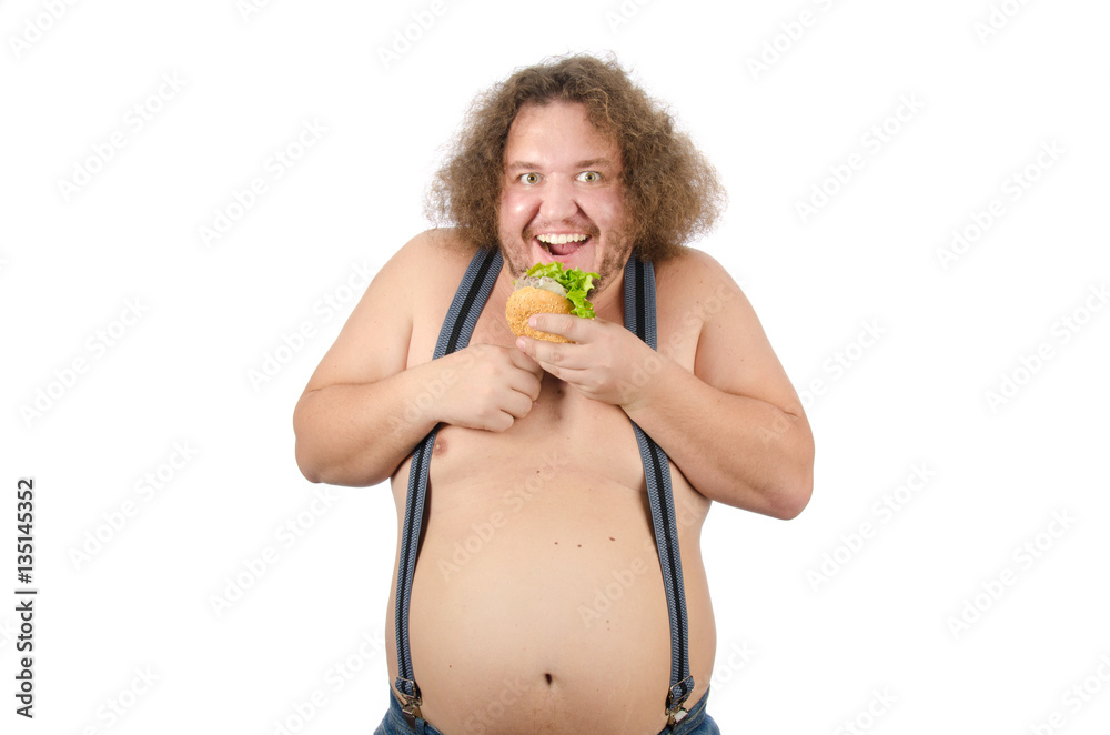 Fat man eating a hamburger. Hunger and burger. Funny guy shirtless and fast food. 
