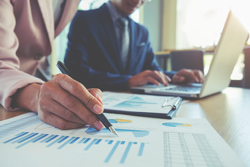 Business concept. Business people discussing the charts and graphs showing the results of their successful teamwork.