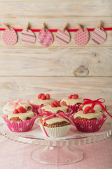 Easter cupcakes with white icing decorated with pink candy and r