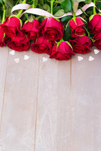 Dark Red Buds Of Valentines Day Roses On Wood With Pink Ribbon And Hearts, Copy Space On Gray Wooden Planks