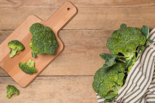 Top view of Fresh green broccoli on rustic wooden background - h