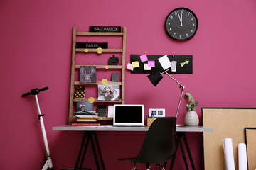 Wall Mural - Workplace with laptop on table in modern room