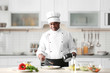 © Africa Studio - Mature Indian chef cooking in kitchen