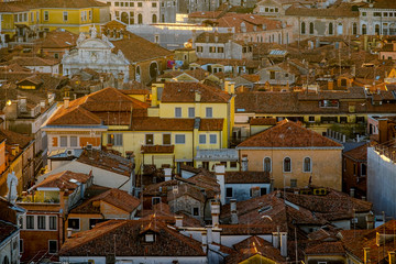 Wall Mural - Panoramic aerial cityscape of Venice,with rooftops, the sea at sunset, Veneto, Italy.