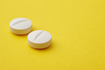 Pills over a yellow background. Medicament treatment. Health car