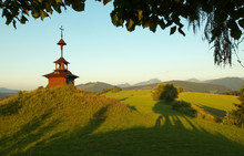 View Of A Meadow With A Small Chapel And Mountains  In Slovakia