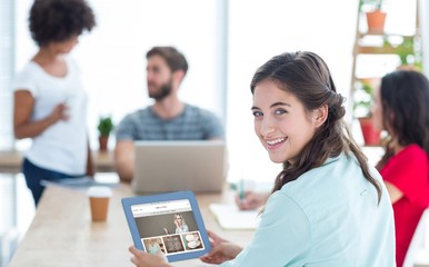 Wall Mural - Composite image of smiling businesswoman using tablet 