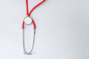 red stethoscope and medical report on clean table