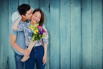 Wall Mural - Composite image of man with bouquet kissing woman