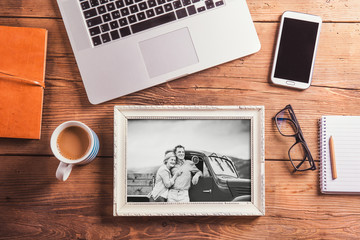 Office desk. Objects and black-and-white photo of senior couple